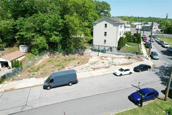 a white car parked in front of a house
