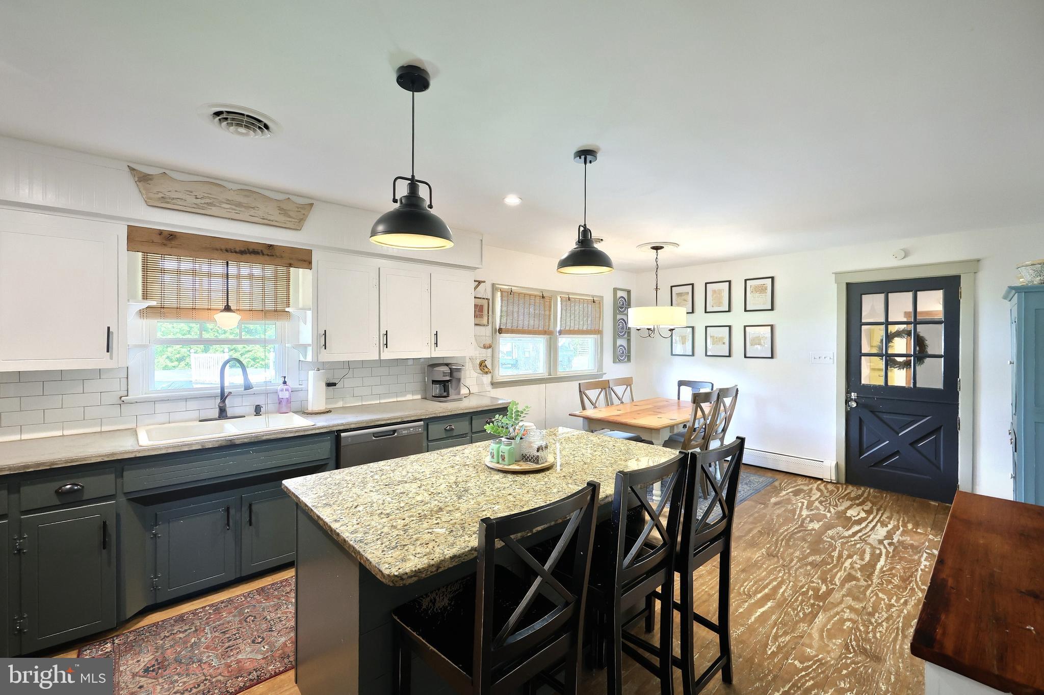 492 Bollinger Road Littlestown, PA 17340 - Photo 15 of 47 a view of a dining room and a kitchen with a table chairs