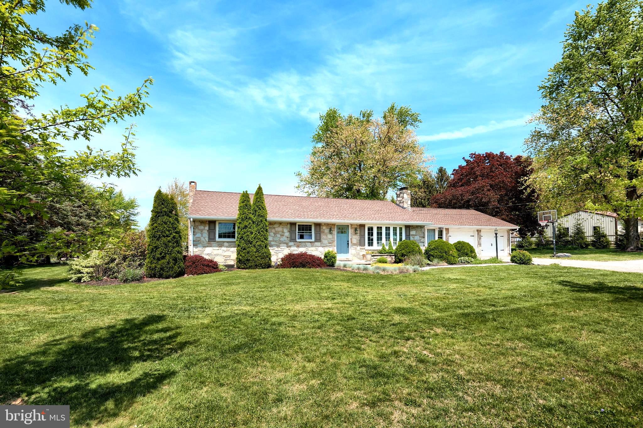 492 Bollinger Road Littlestown, PA 17340 - Photo 2 of 47 a front view of a house with a garden