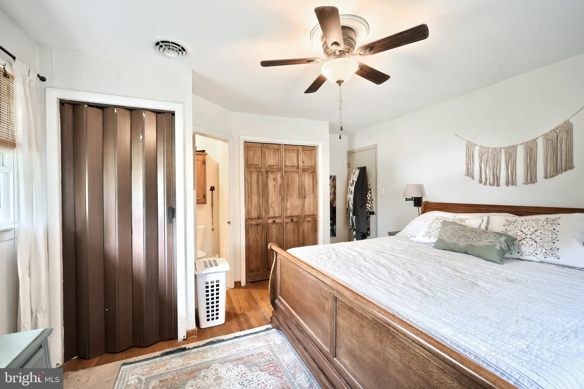 492 Bollinger Road Littlestown, PA 17340 - Photo 25 of 47 a spacious bedroom with a large bed and a chandelier