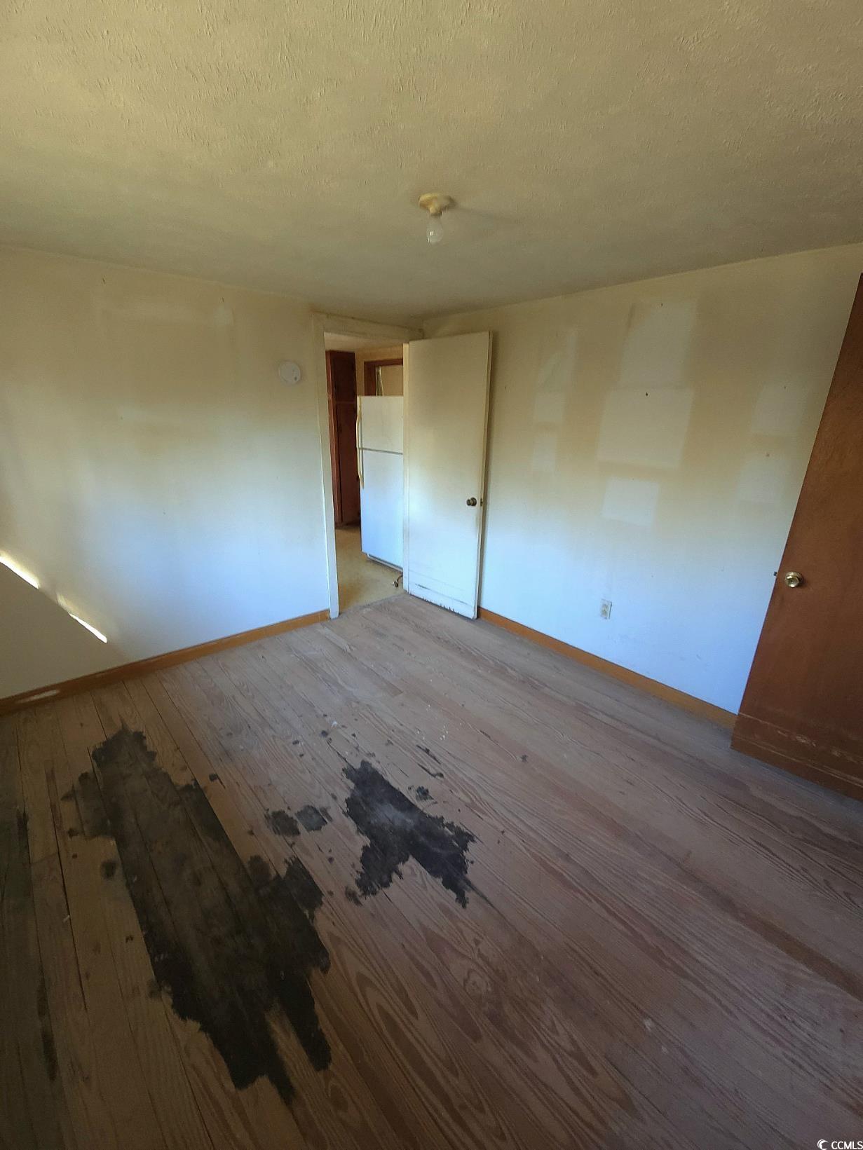 150 Landmark Road Conway, SC 29527 - Photo 14 of 35 Unfurnished bedroom with a textured ceiling, wood-type flooring, and freestanding refrigerator