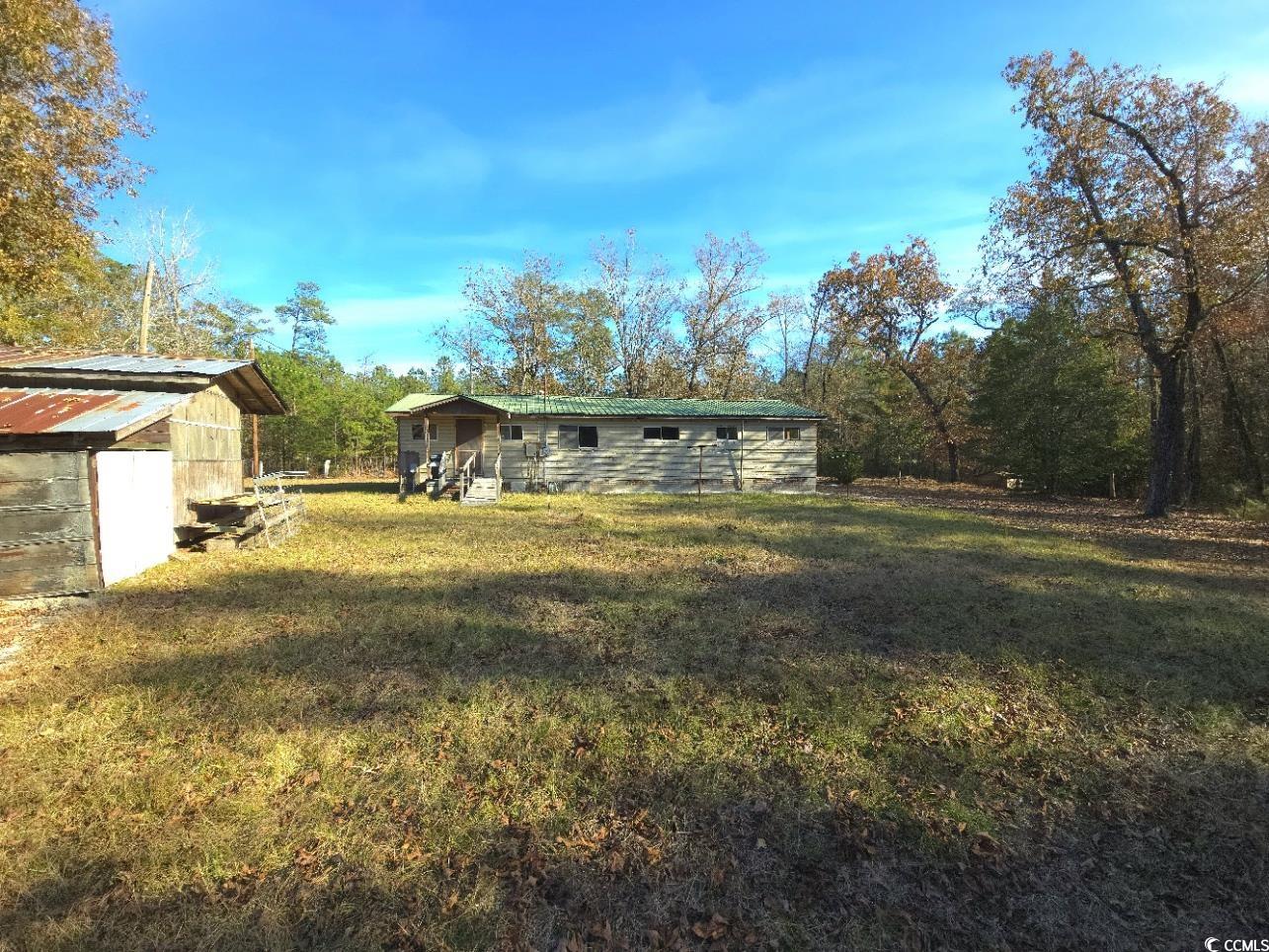 150 Landmark Road Conway, SC 29527 - Photo 28 of 35 Back of property featuring a lawn and an outbuilding