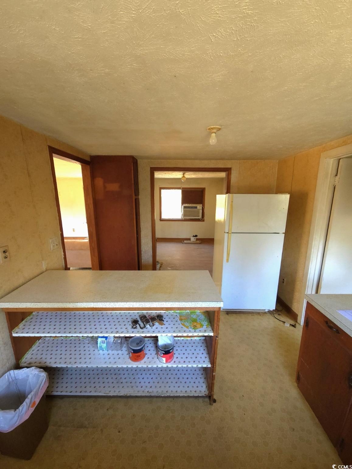 150 Landmark Road Conway, SC 29527 - Photo 9 of 35 Kitchen featuring freestanding refrigerator, light countertops, light carpet, a textured ceiling, and a peninsula