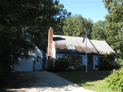 136 Ebenezer Road Osterville, MA 02655 - Photo 1 of 10 a front view of house with yard and green space