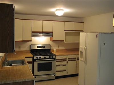 136 Ebenezer Road Osterville, MA 02655 - Photo 5 of 10 a kitchen with granite countertop a stove and a refrigerator