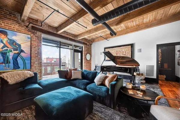 a living room with furniture and a dining table