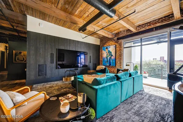 a living room with furniture and a flat screen tv