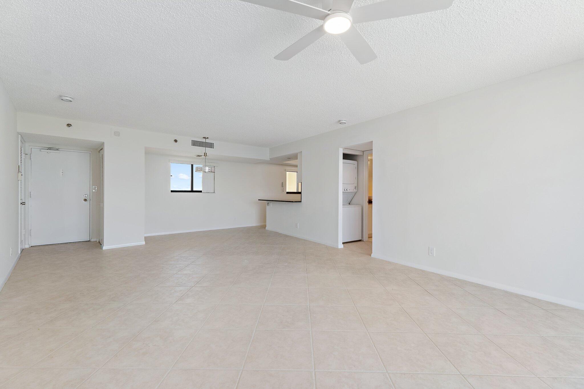 300 Ocean Trail Way, Unit 1406 Jupiter, FL 33477 - Photo 21 of 42 an empty room with windows and fireplace