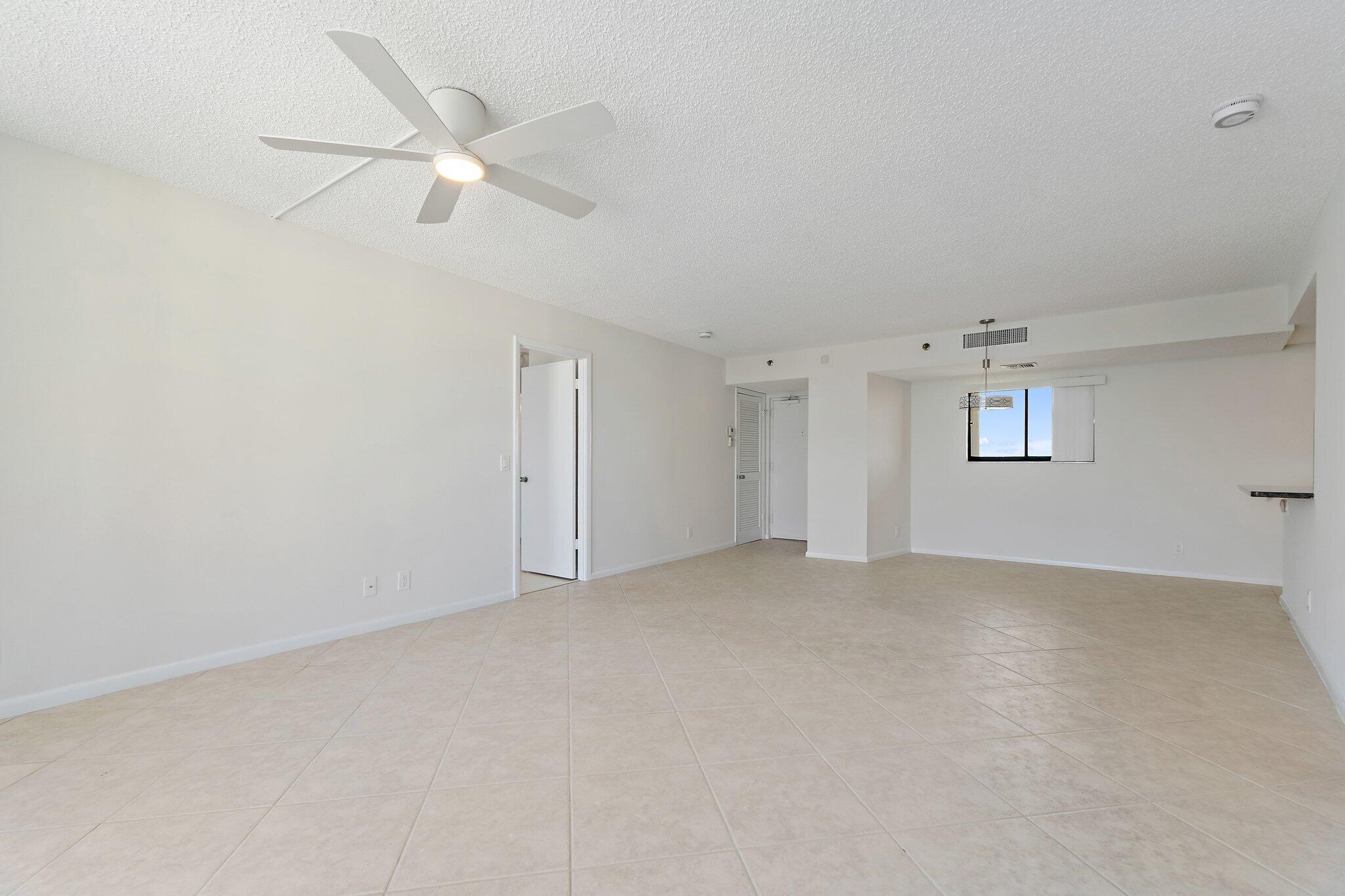 300 Ocean Trail Way, Unit 1406 Jupiter, FL 33477 - Photo 22 of 42 an empty room with staircase and white walls