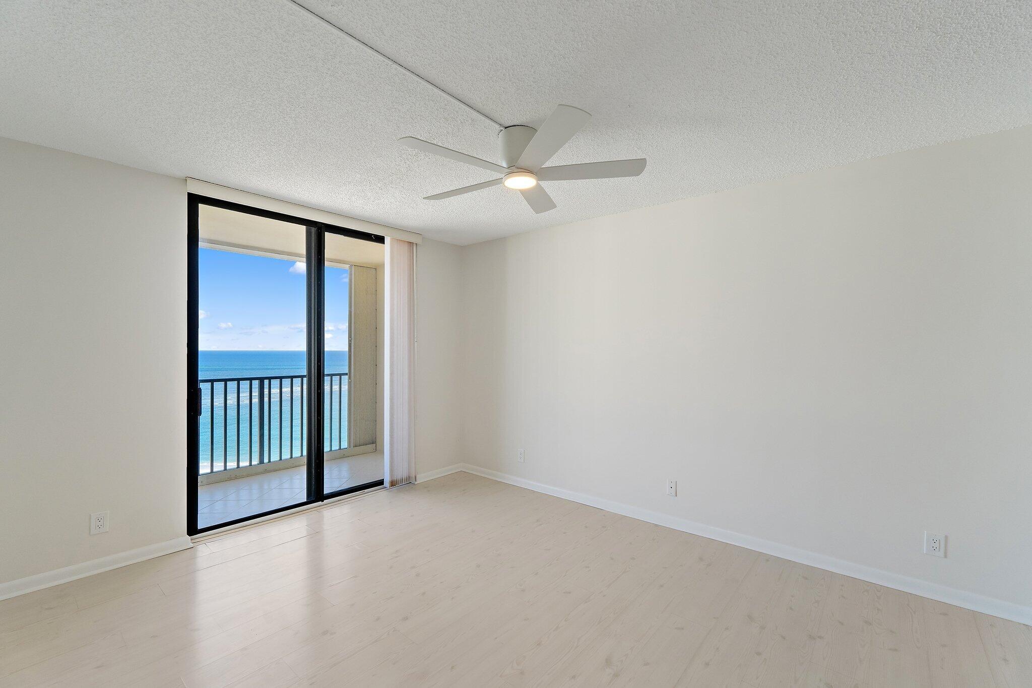 300 Ocean Trail Way, Unit 1406 Jupiter, FL 33477 - Photo 24 of 42 an empty room with windows and fan