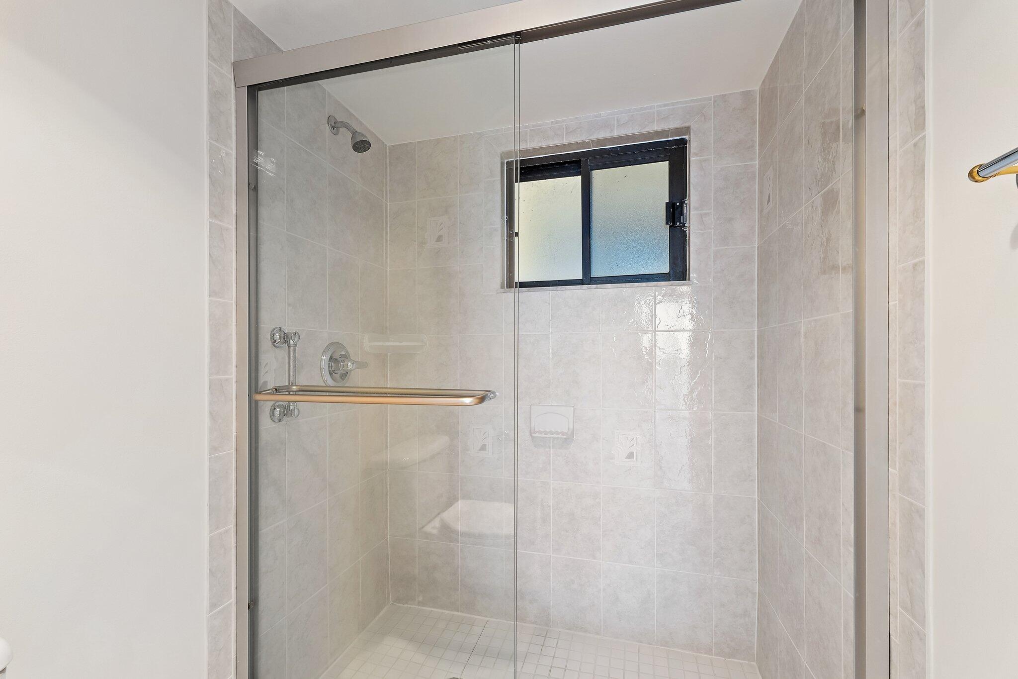 300 Ocean Trail Way, Unit 1406 Jupiter, FL 33477 - Photo 31 of 42 a bathroom with a shower