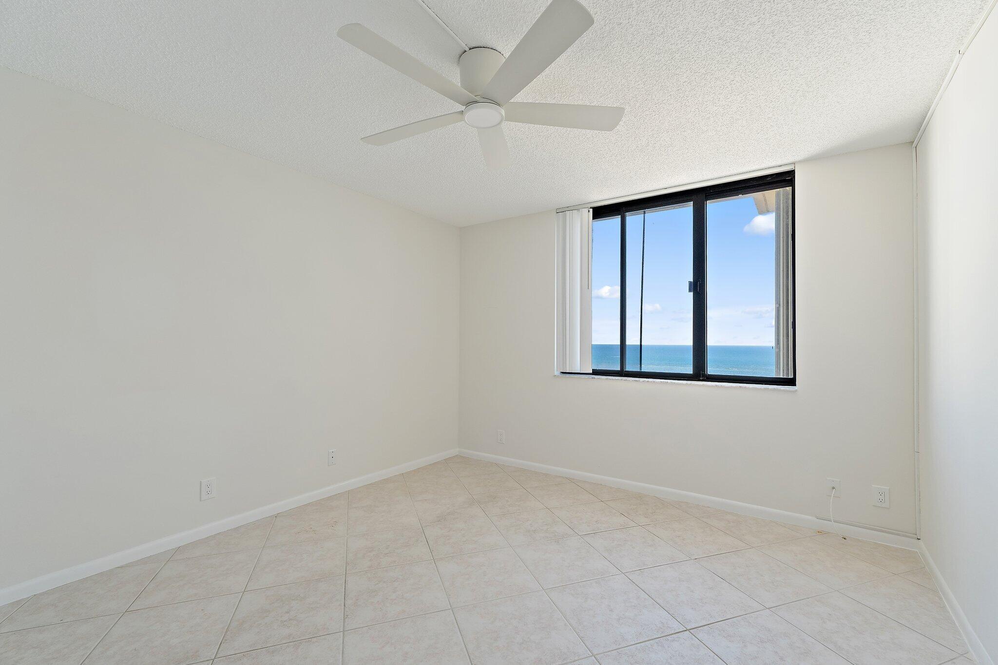 300 Ocean Trail Way, Unit 1406 Jupiter, FL 33477 - Photo 38 of 42 an empty room with windows and fan