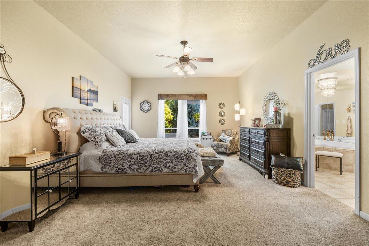 1105 Pumpkin Ridge Eagle Point, OR 97524 - Photo 15 of 40 a bedroom with bed and a chandelier