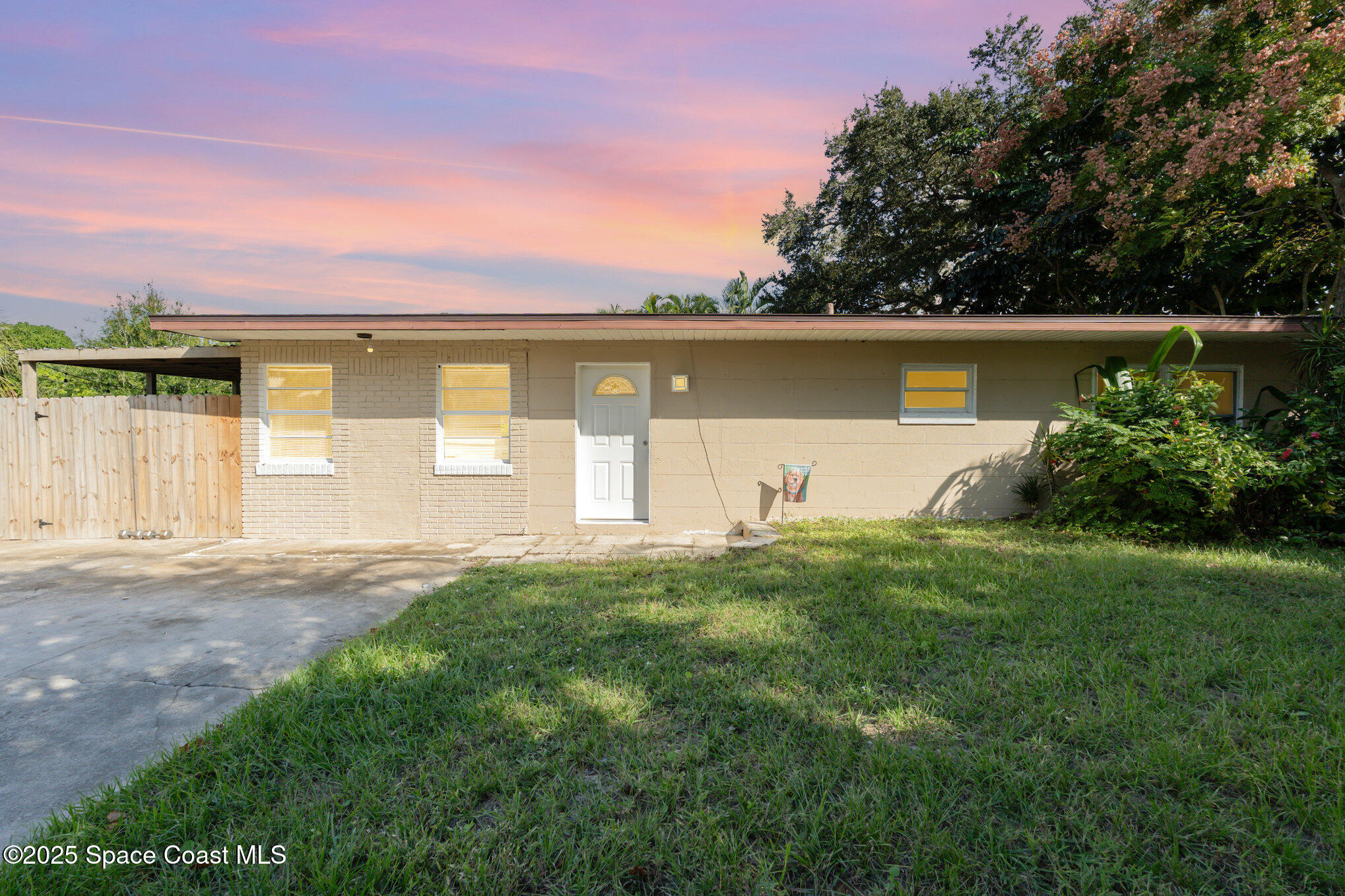 1137 Delmar Terrace Palm Bay, FL 32905 - Photo 1 of 35 a front view of a house with garden