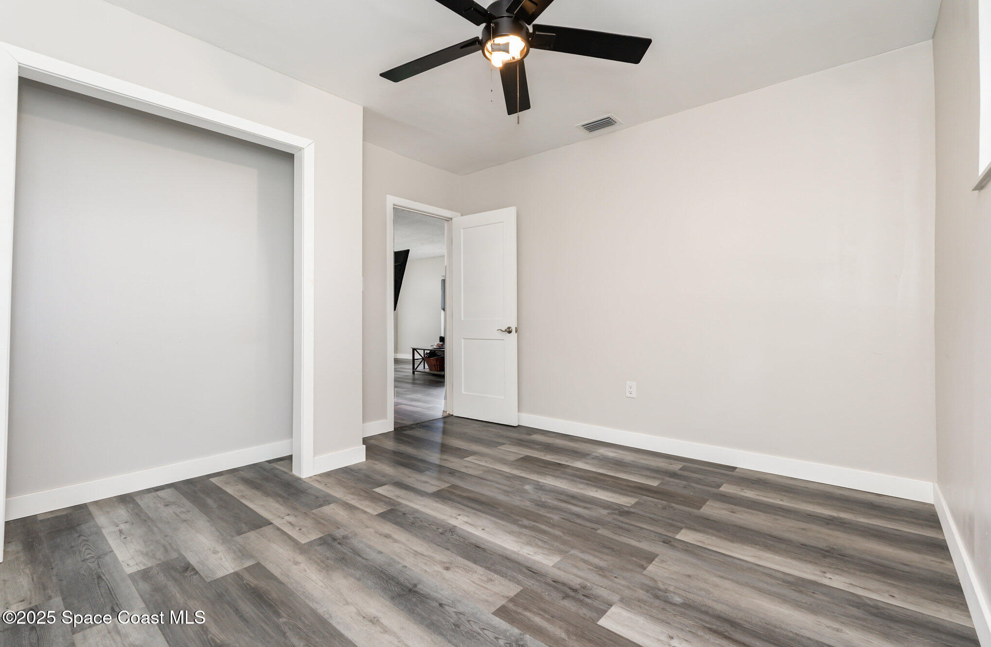 1137 Delmar Terrace Palm Bay, FL 32905 - Photo 11 of 35 a view of empty room with wooden floor