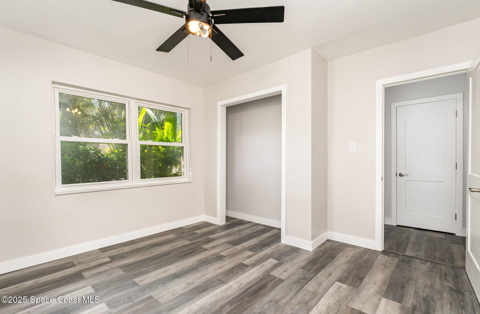 1137 Delmar Terrace Palm Bay, FL 32905 - Photo 12 of 35 a view of a room with a ceiling fan and a window
