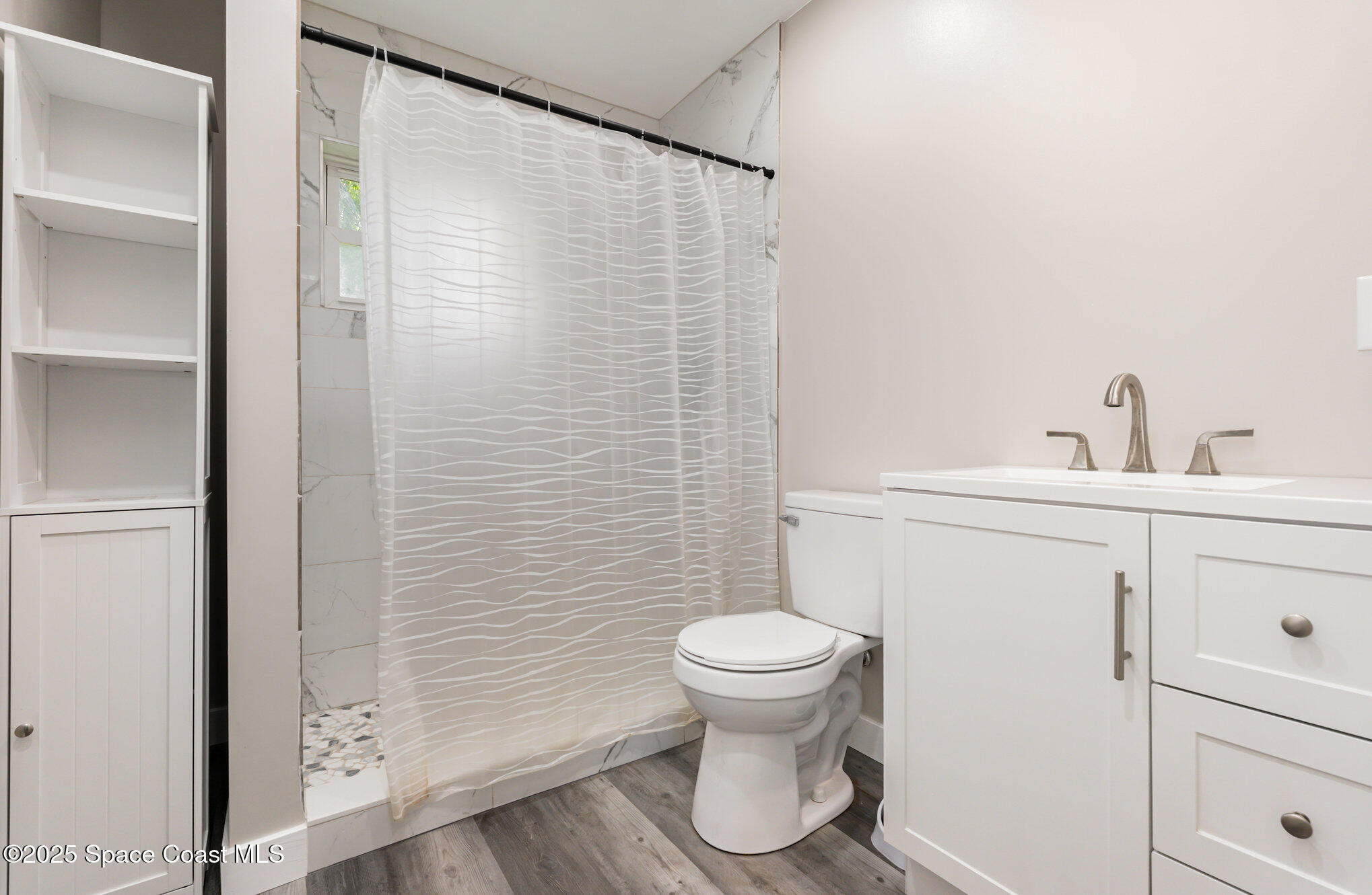1137 Delmar Terrace Palm Bay, FL 32905 - Photo 15 of 35 a bathroom with a sink and a toilet