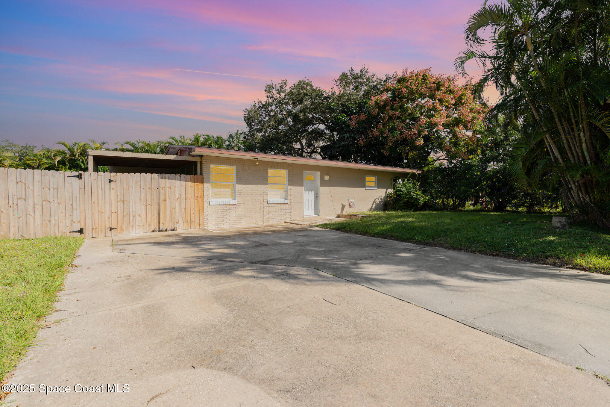 1137 Delmar Terrace Palm Bay, FL 32905 - Photo 29 of 35 a front view of a house with a yard and garage