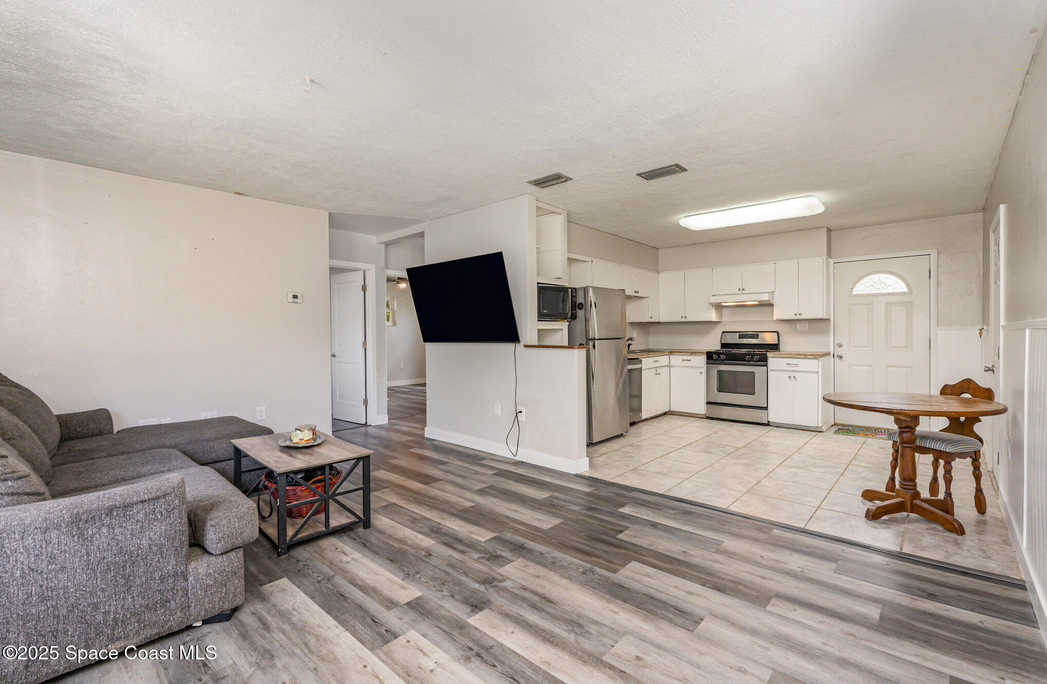 1137 Delmar Terrace Palm Bay, FL 32905 - Photo 34 of 35 a living room with furniture and a flat screen tv