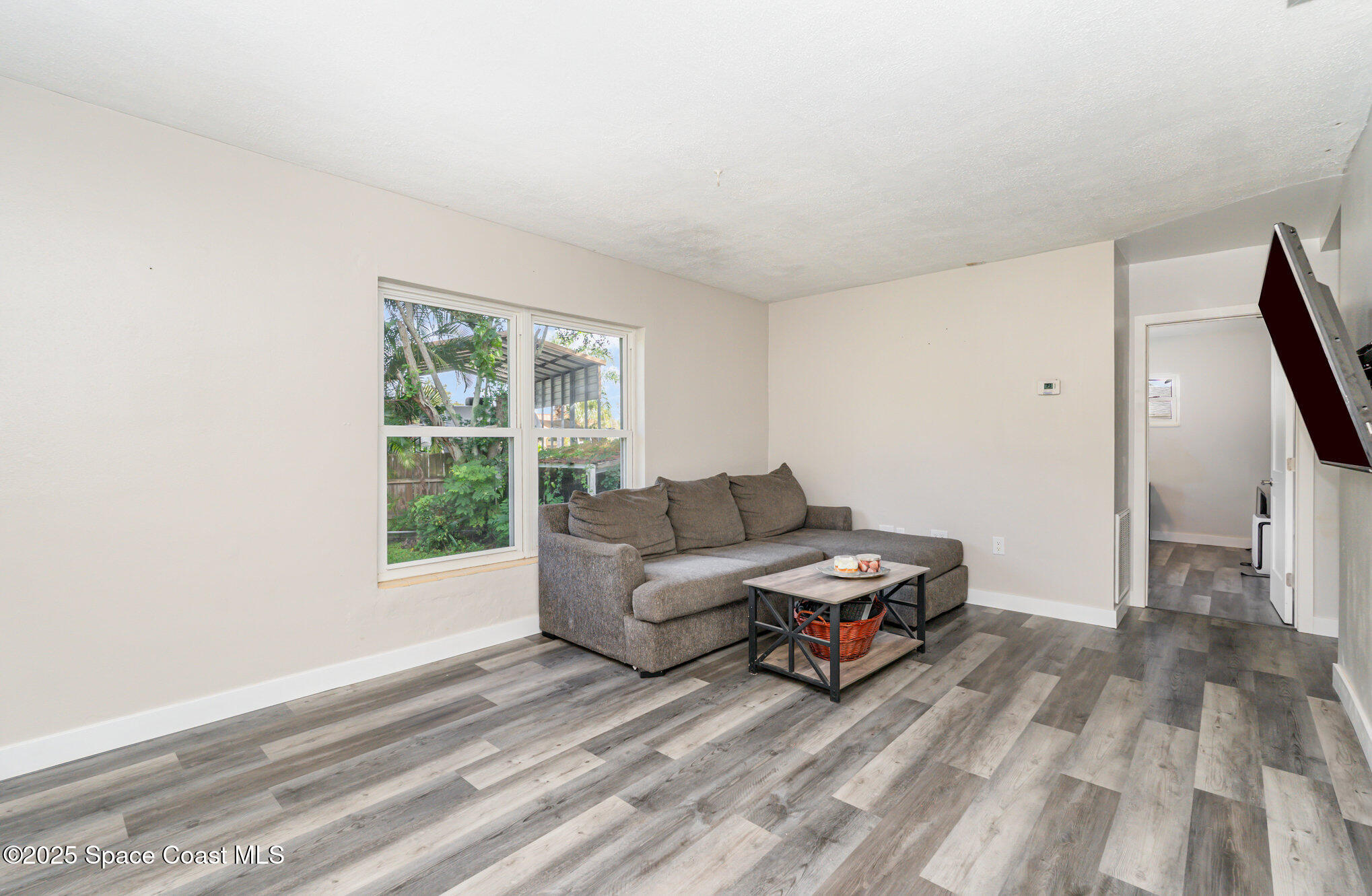 1137 Delmar Terrace Palm Bay, FL 32905 - Photo 5 of 35 a living room with furniture and a window