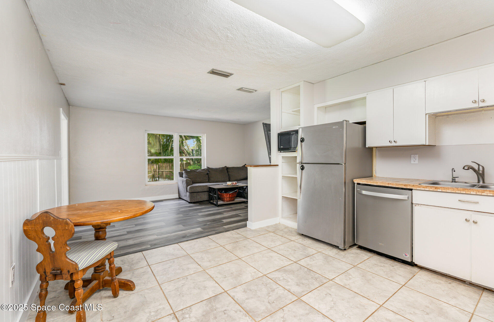 1137 Delmar Terrace Palm Bay, FL 32905 - Photo 7 of 35 a kitchen with stainless steel appliances kitchen island granite countertop a refrigerator and a stove top oven