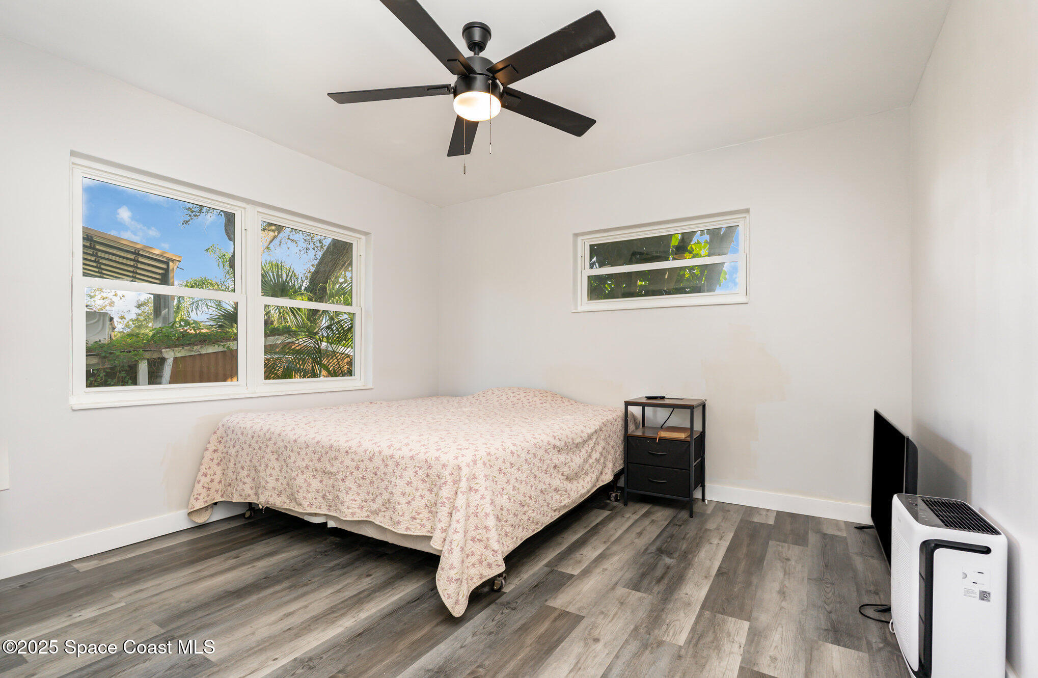1137 Delmar Terrace Palm Bay, FL 32905 - Photo 8 of 35 a bedroom with a bed and a tv