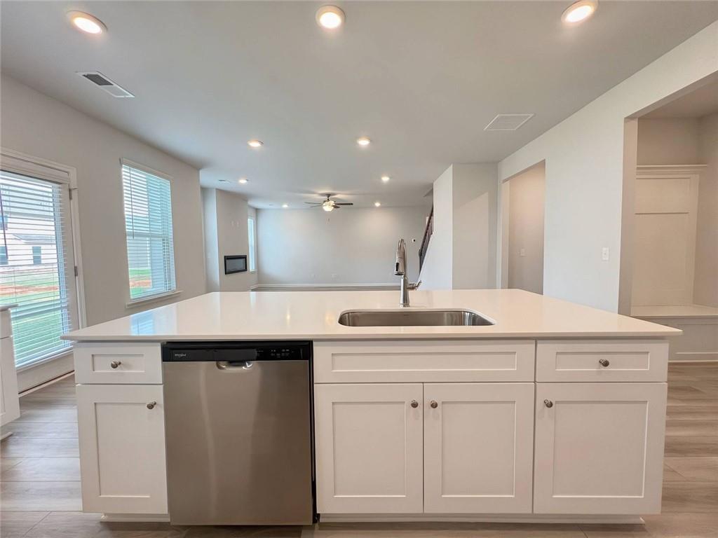 2790 Dolce Road Dacula, GA 30019 - Photo 12 of 66 a kitchen with white cabinets appliances and a sink