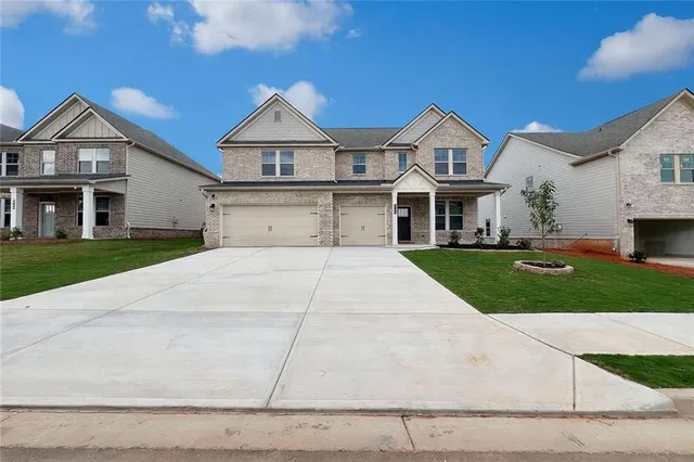 a view of a hallway with wooden floor and a bathroom