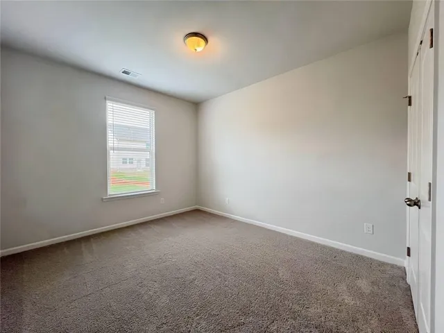 a view of a house with a big yard and large trees