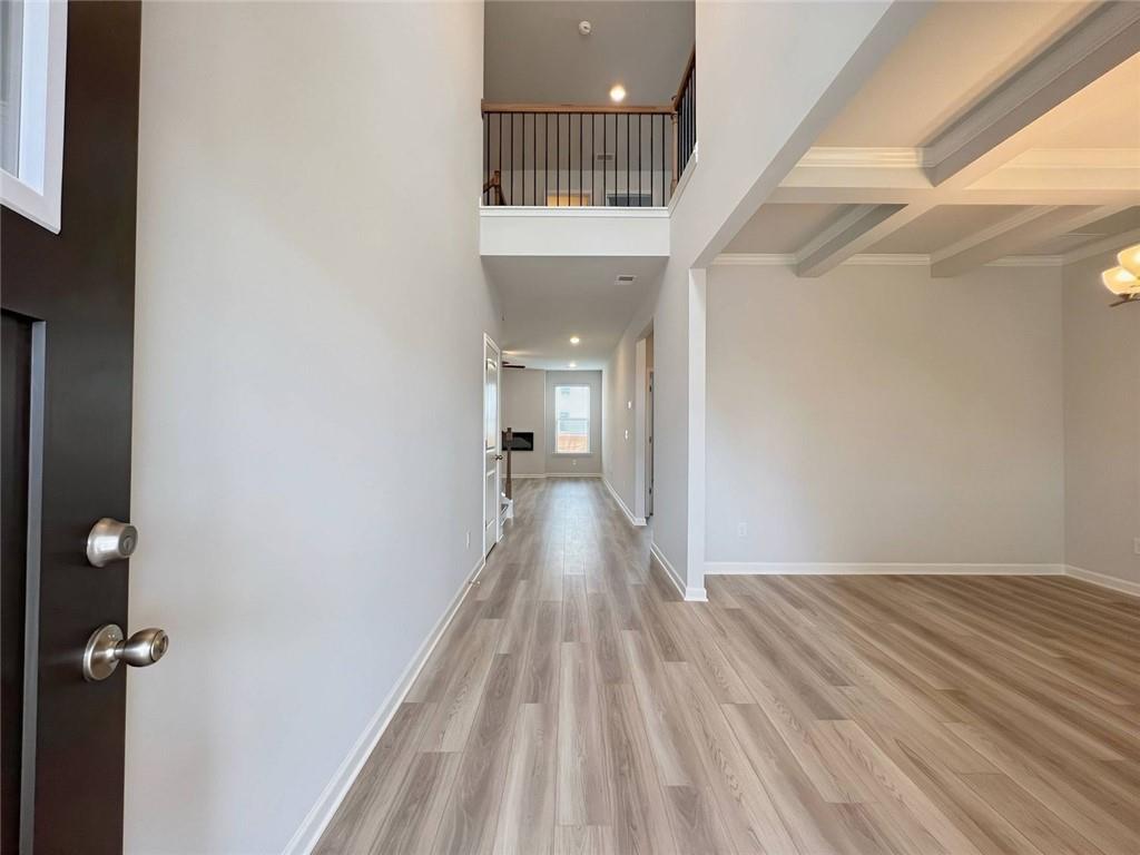 2790 Dolce Road Dacula, GA 30019 - Photo 3 of 66 a view of a hallway with wooden floor and a bathroom