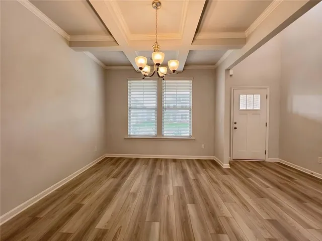 a kitchen with white cabinets appliances and a sink