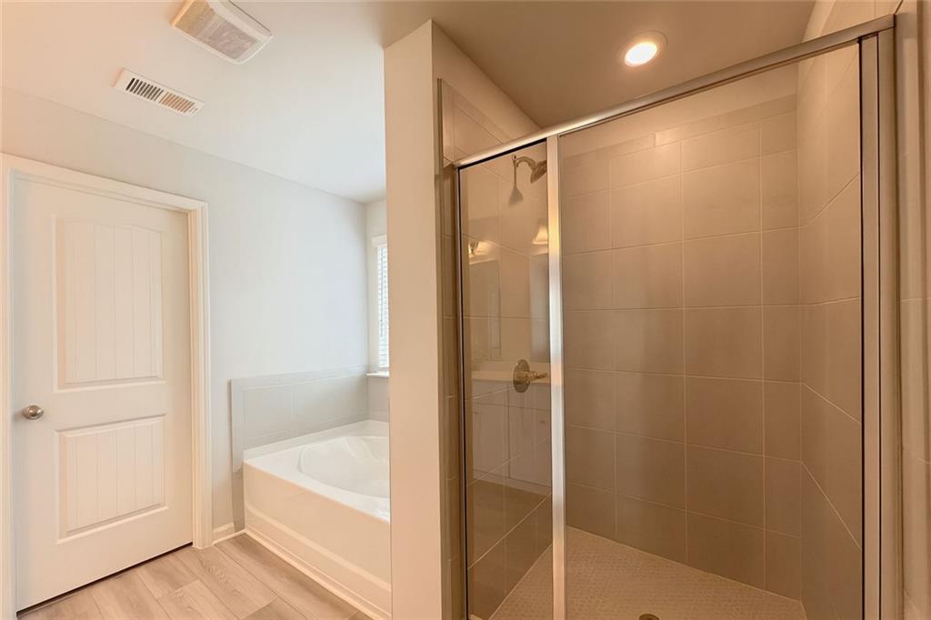 2790 Dolce Road Dacula, GA 30019 - Photo 50 of 66 a bathroom with a shower and a bath tub