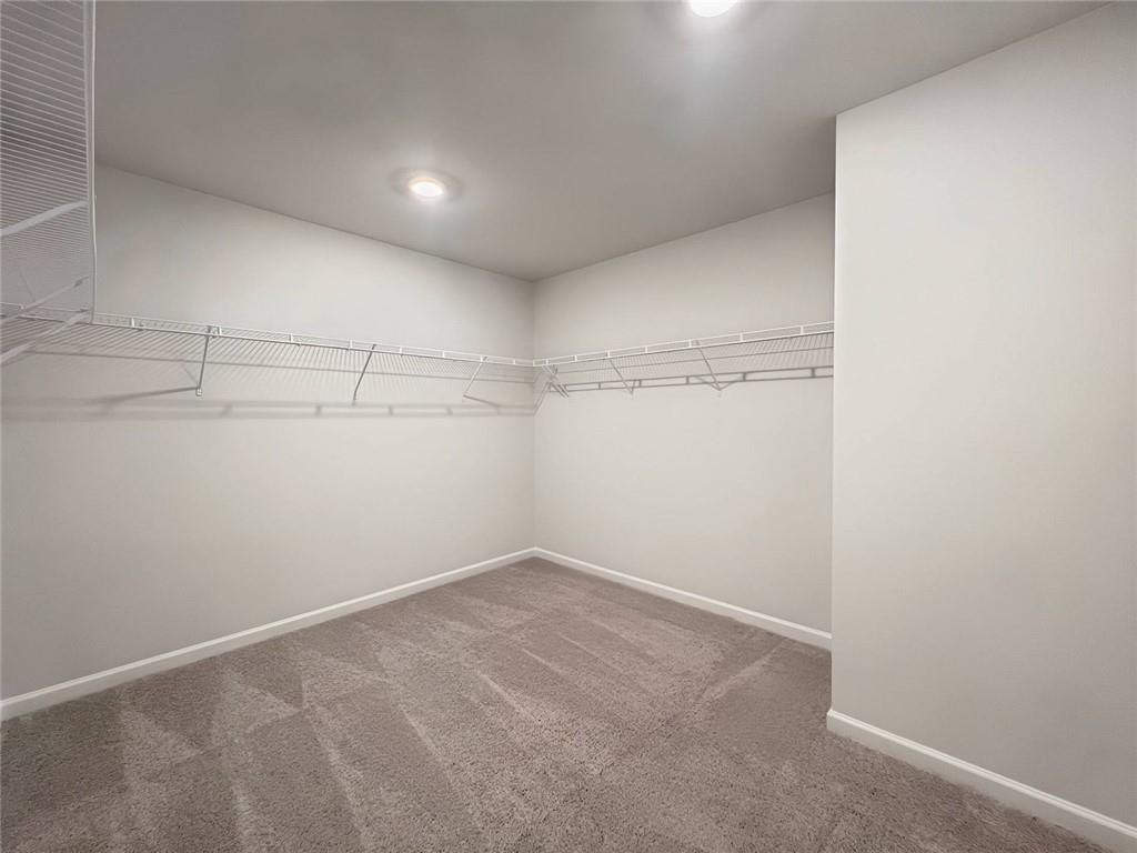 2790 Dolce Road Dacula, GA 30019 - Photo 54 of 66 a view of a room with racks on the wall