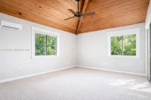 a storage room with stainless steel appliances a refrigerator and window
