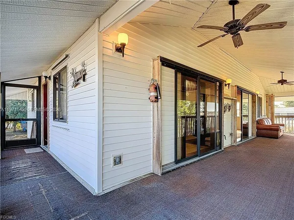 a view of a porch with furniture and floor to ceiling window