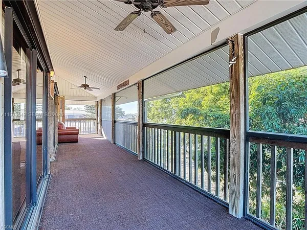 a view of a porch with wooden floor and outdoor space