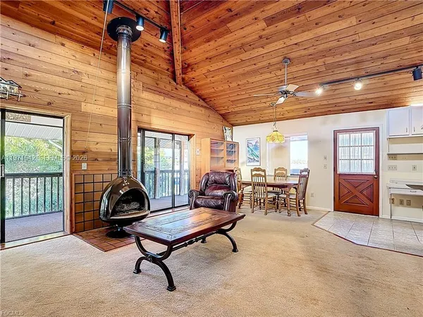 a living room with furniture a rug and a large window