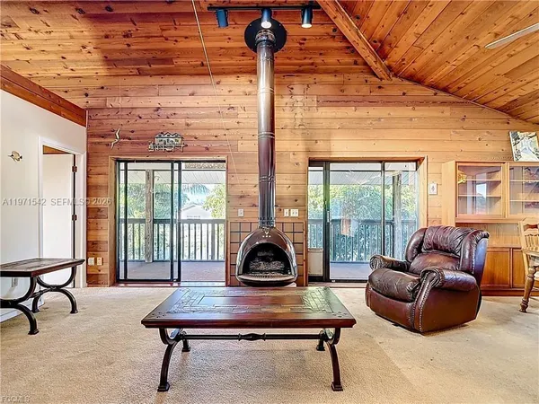 a living room with furniture a ceiling fan and a window