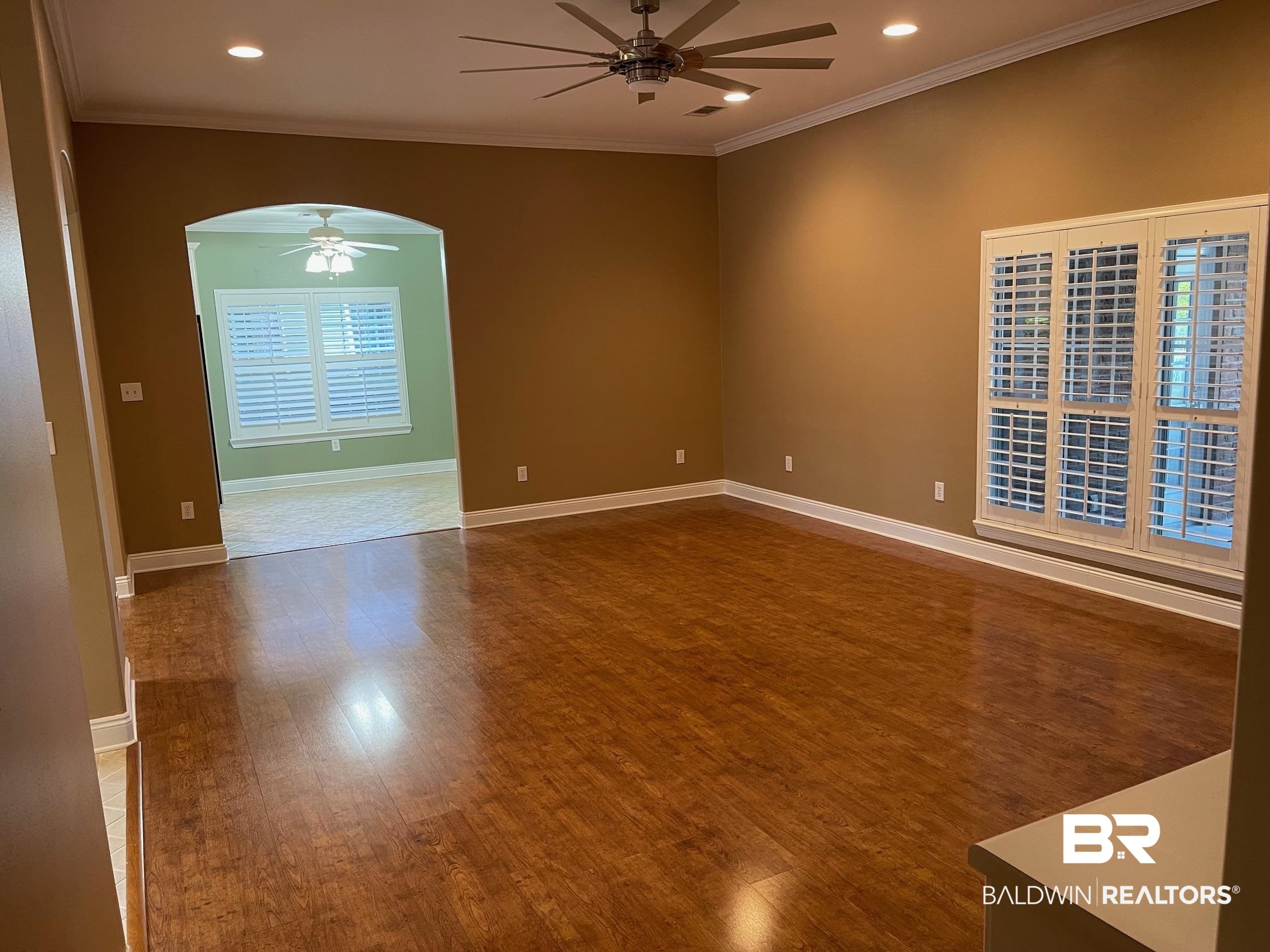 109 Savannah Circle Foley, AL 36535 - Photo 5 of 17 Empty room with crown molding, ceiling fan, and hardwood / wood-style flooring