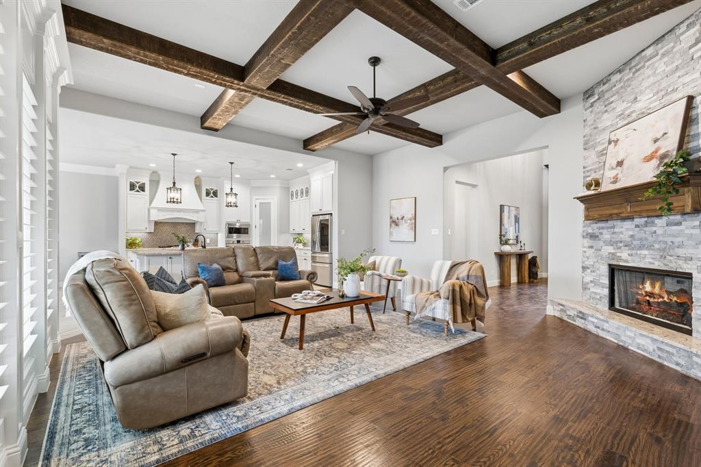 104 Ryder Court Hurst, TX 76053 - Photo 6 of 35 Open-Concept Living Anchored By Floor-To-Ceiling Austin Stone Fireplace And Wood Beams