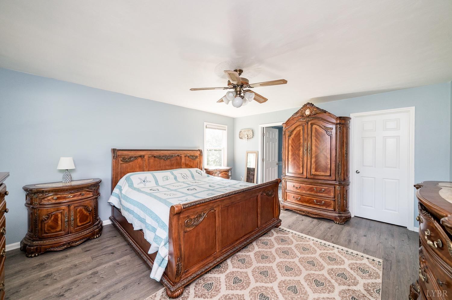 7996 Rocky Ford Road Moneta, VA 24121 - Photo 11 of 45 a bedroom with a bed and a chandelier