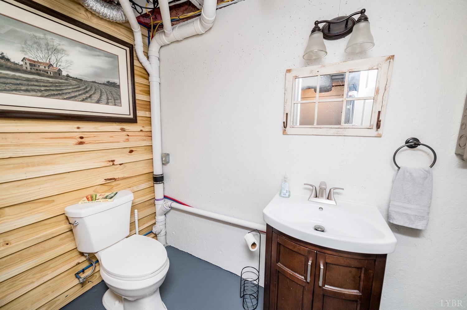 7996 Rocky Ford Road Moneta, VA 24121 - Photo 24 of 45 a bathroom with a sink mirror and toilet
