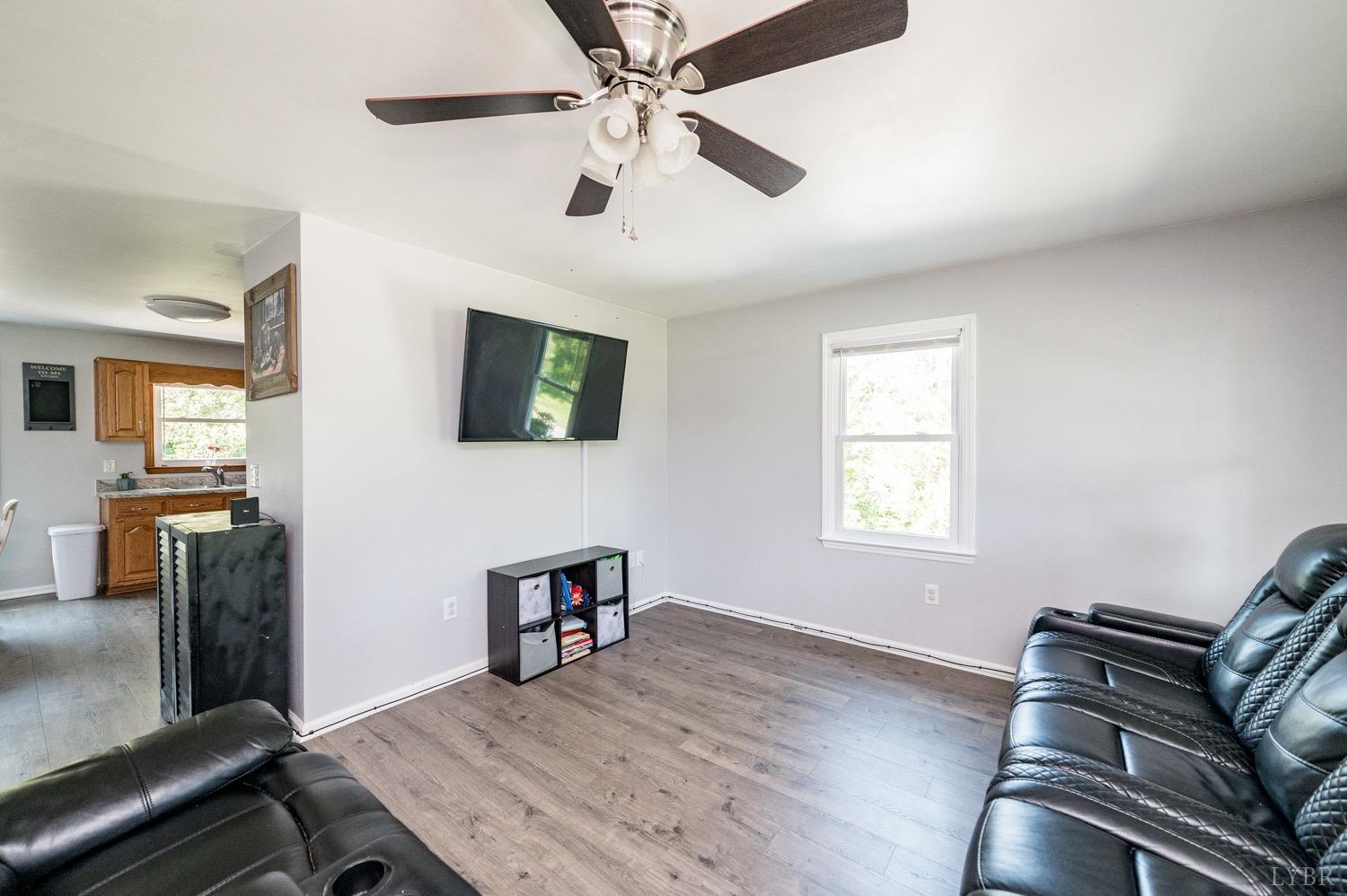 7996 Rocky Ford Road Moneta, VA 24121 - Photo 3 of 45 a living room with furniture and a flat screen tv