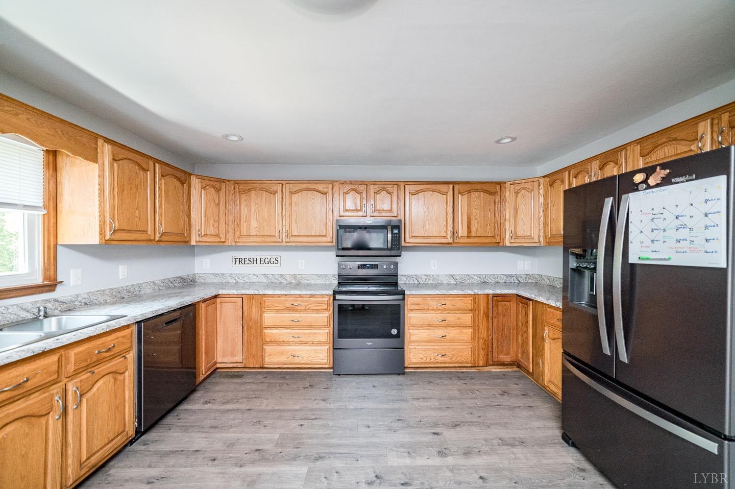 7996 Rocky Ford Road Moneta, VA 24121 - Photo 6 of 45 a kitchen with stainless steel appliances granite countertop a refrigerator and a sink