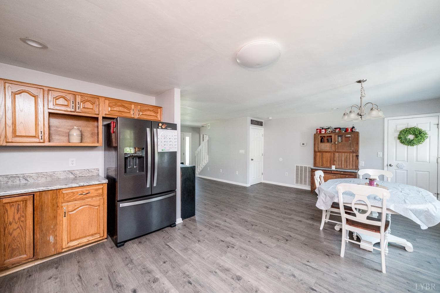 7996 Rocky Ford Road Moneta, VA 24121 - Photo 9 of 45 a kitchen with stainless steel appliances wooden floor and chairs
