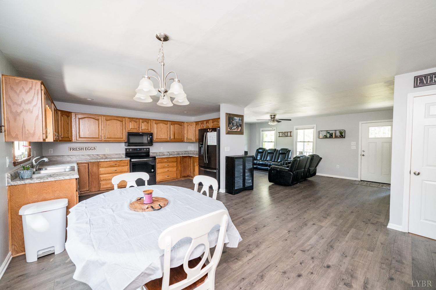 7996 Rocky Ford Road Moneta, VA 24121 - Photo 10 of 45 a bed room with furniture and a chandelier