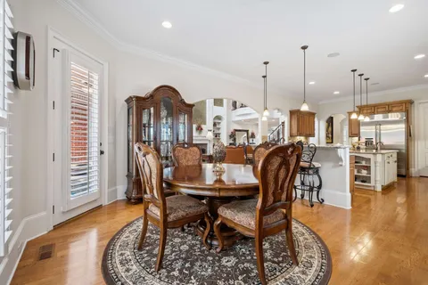 a view of a dining room with furniture and a chandelier