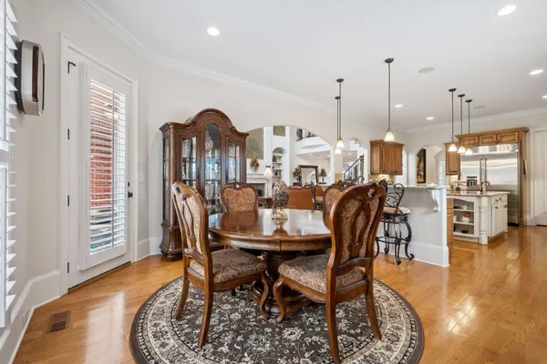 a view of a dining room with furniture and a chandelier
