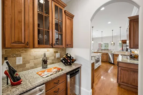 a dining room with furniture potted plants and wooden floor