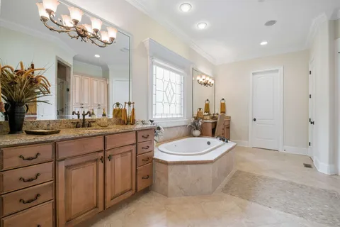 a bathroom with a granite countertop sink a toilet and a mirror